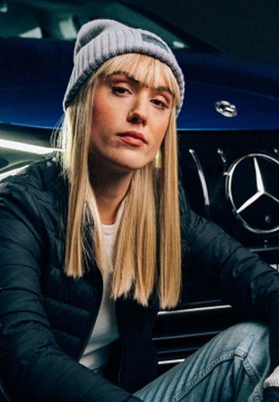 A model wears the beanie from the new Mercedes-AMG Private Lounge collection.